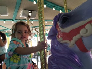 Rose picked out her favorite purple horse on the carousel.